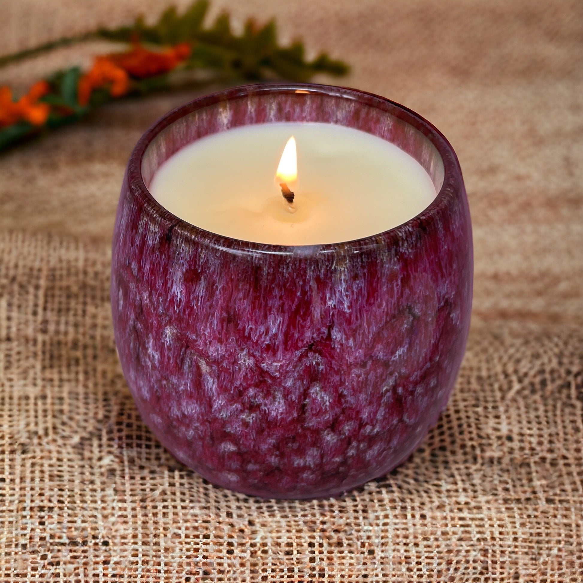 Renewed Vitality candle surrounded by natural elements, celebrating pure aromatherapy and eco wellness