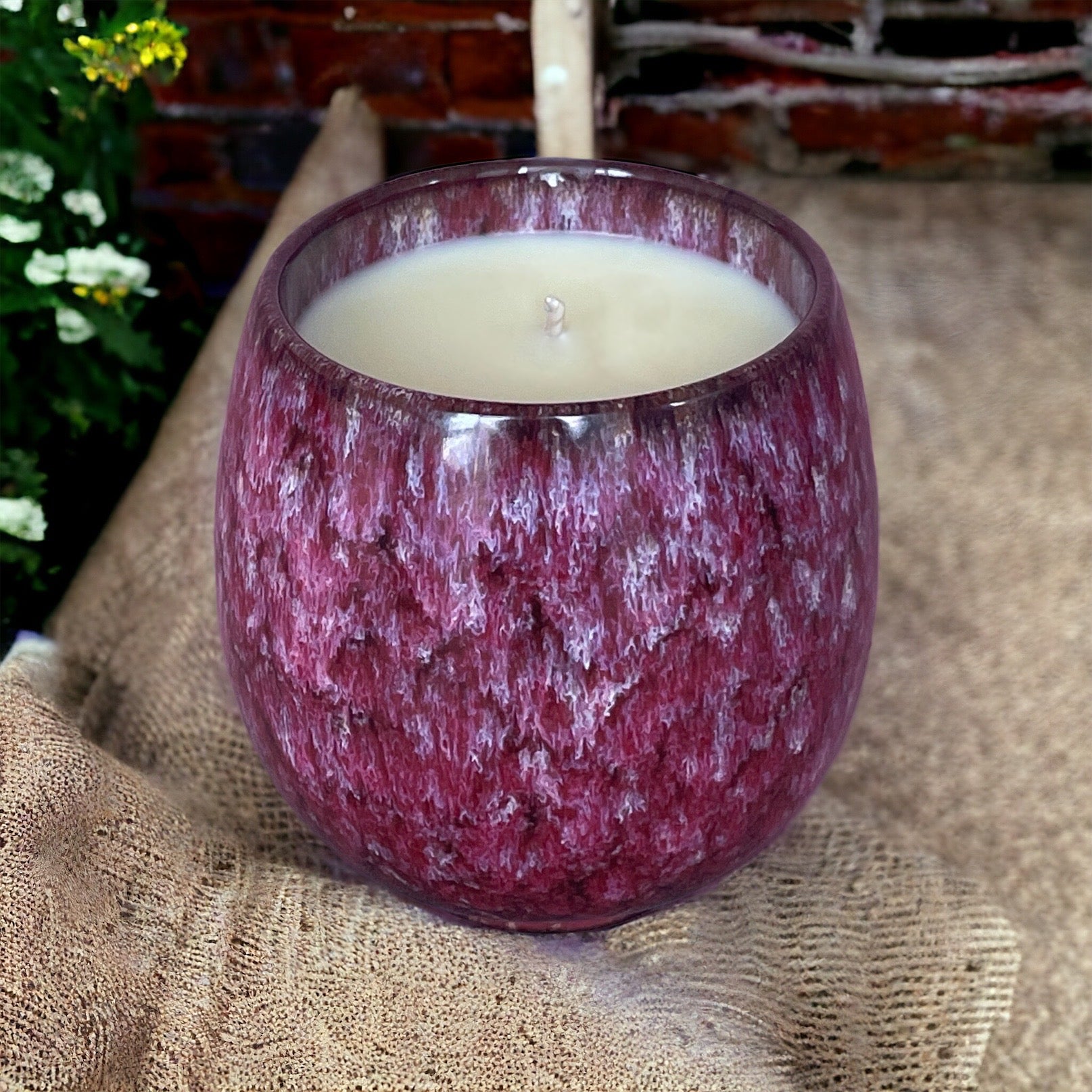 Renewed Vitality aromatherapy candle lit, offering natural energy and mental clarity through pure essential oils