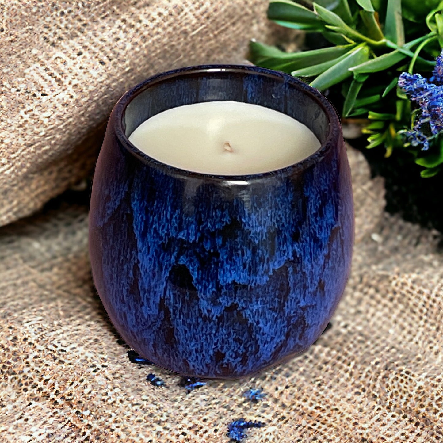 Lit Reset & Unwind aromatherapy candle in a ceramic coffee cup, promoting calm, stress relief, and relaxation