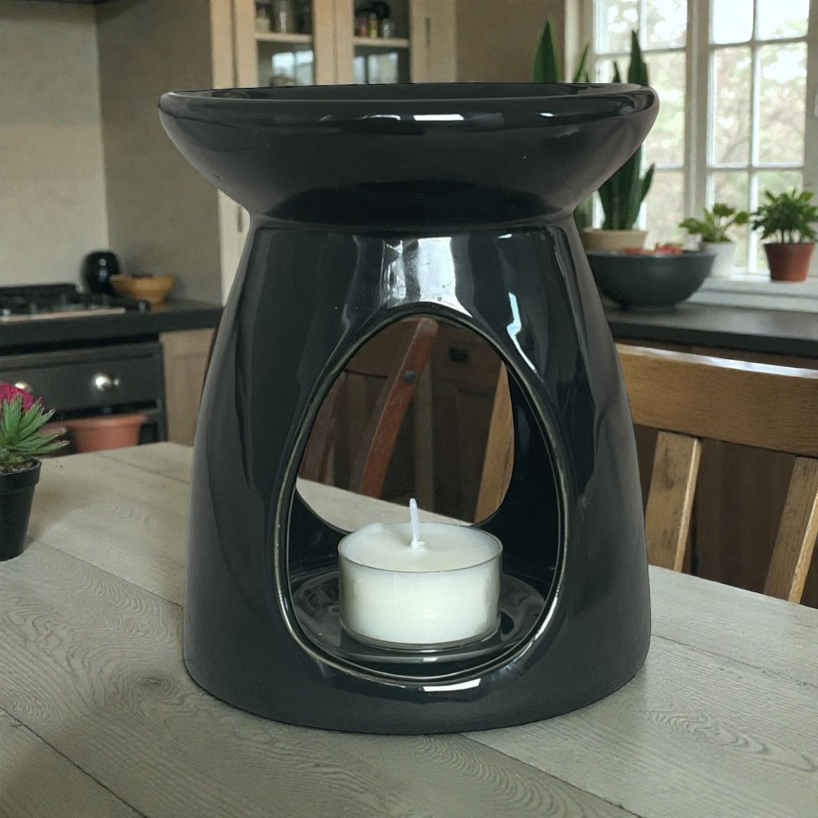 Unscented Mystic Nomad Aromatherapy tea light burning inside a black wax melt burner.