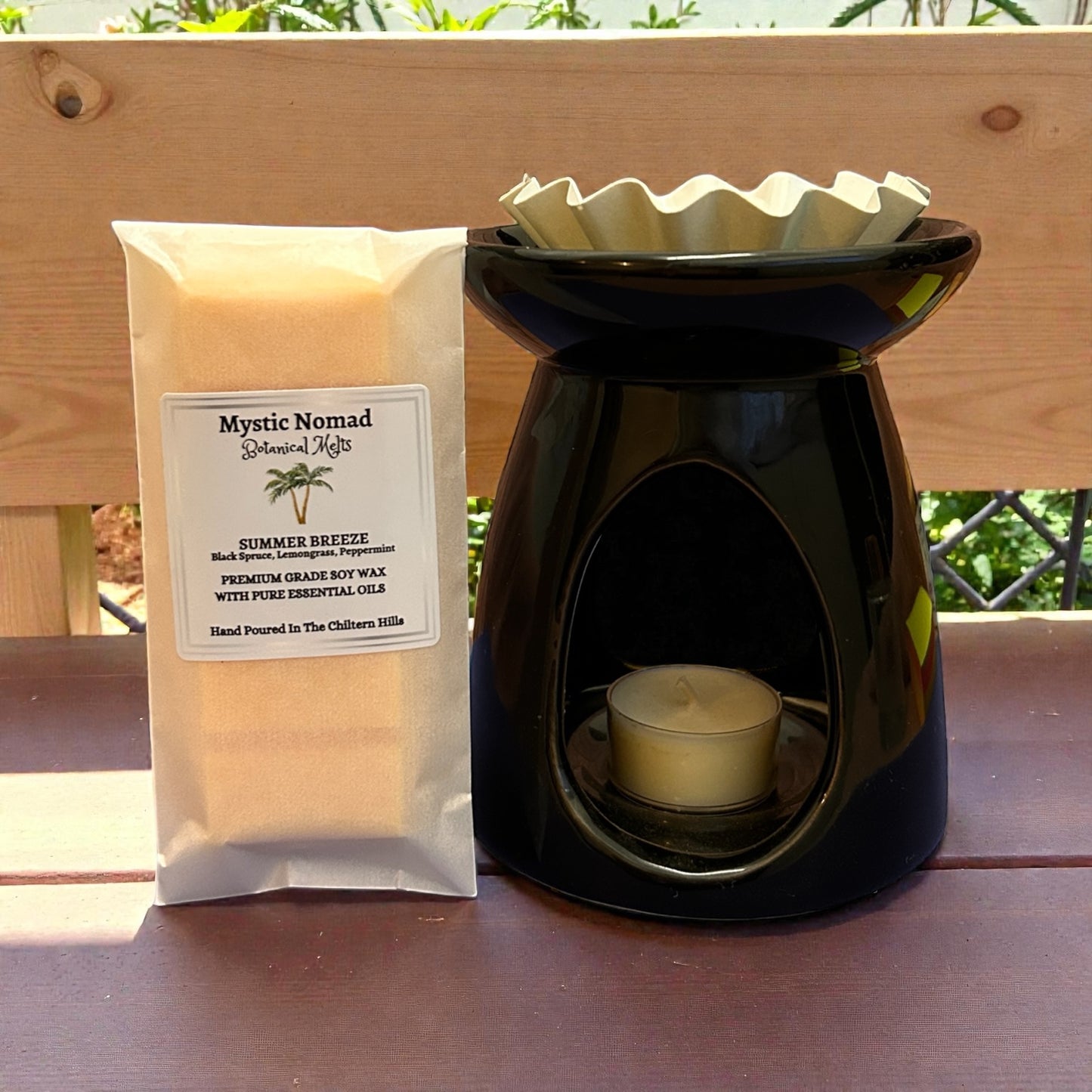 Summer Breeze wax melt snap bar shown with wax melt burner, releasing a bright, refreshing citrus-floral aroma