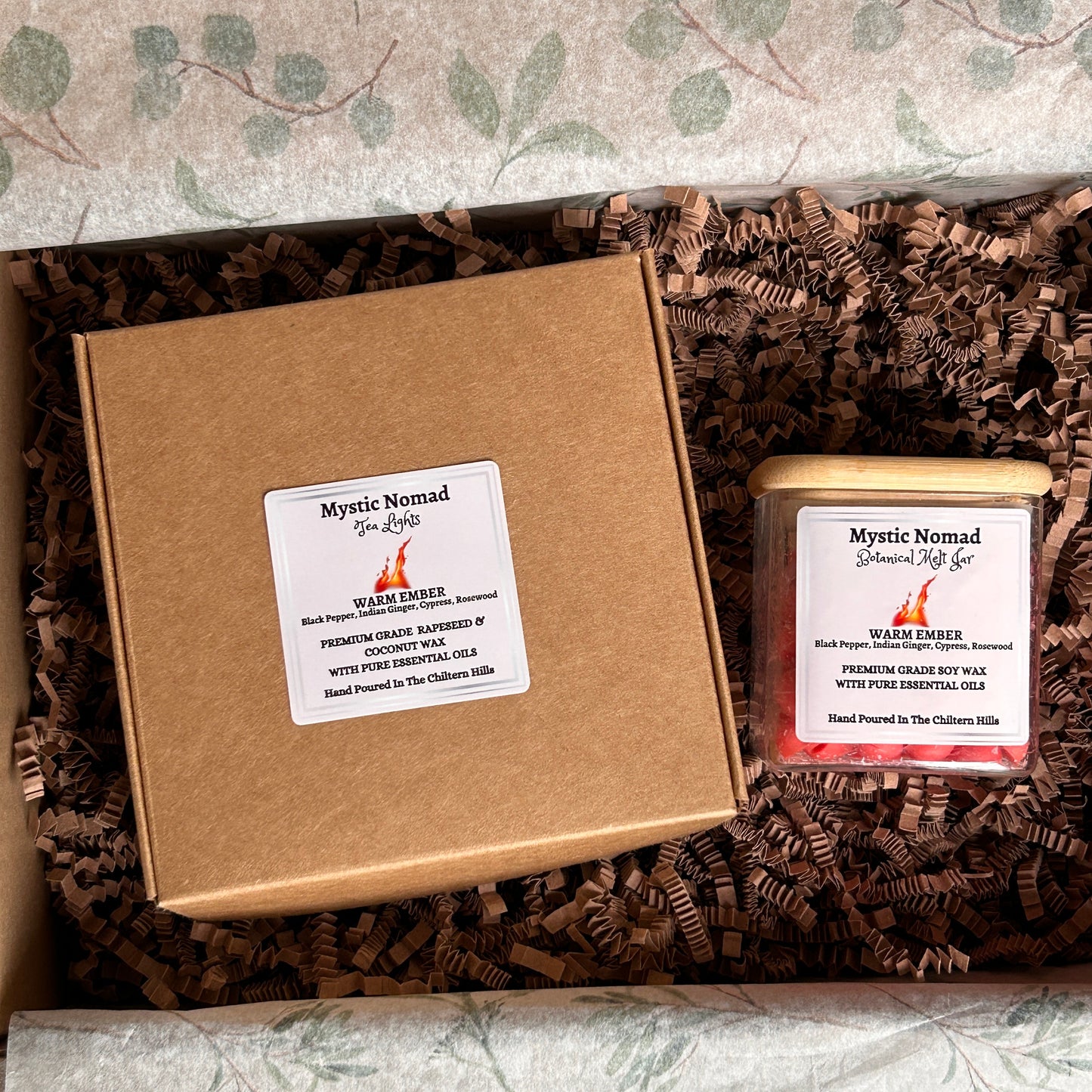 Warm Ember aromatherapy candle tea lights in a postage box alongside matching wax melts, infused with essential oils for grounding and mindfulness.