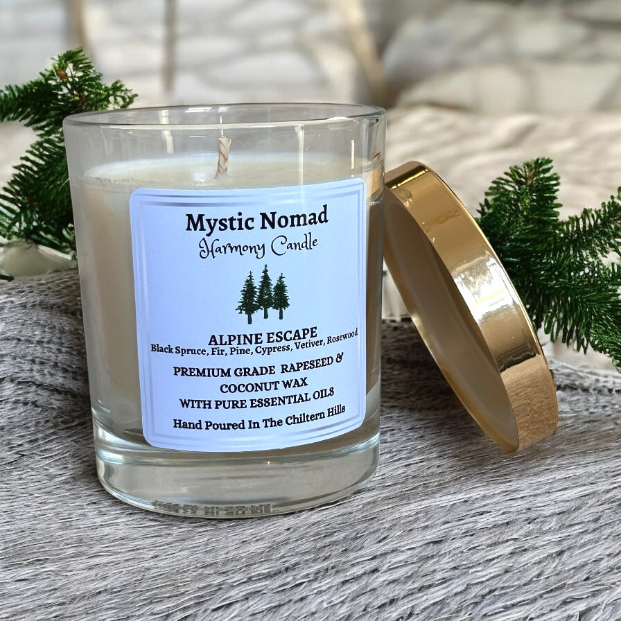 Alpine Escape aromatherapy candle with gold lid placed beside the jar