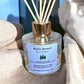 Close-up of Alpine Escape reed diffuser with reeds showing grounding essential oils and natural plant base