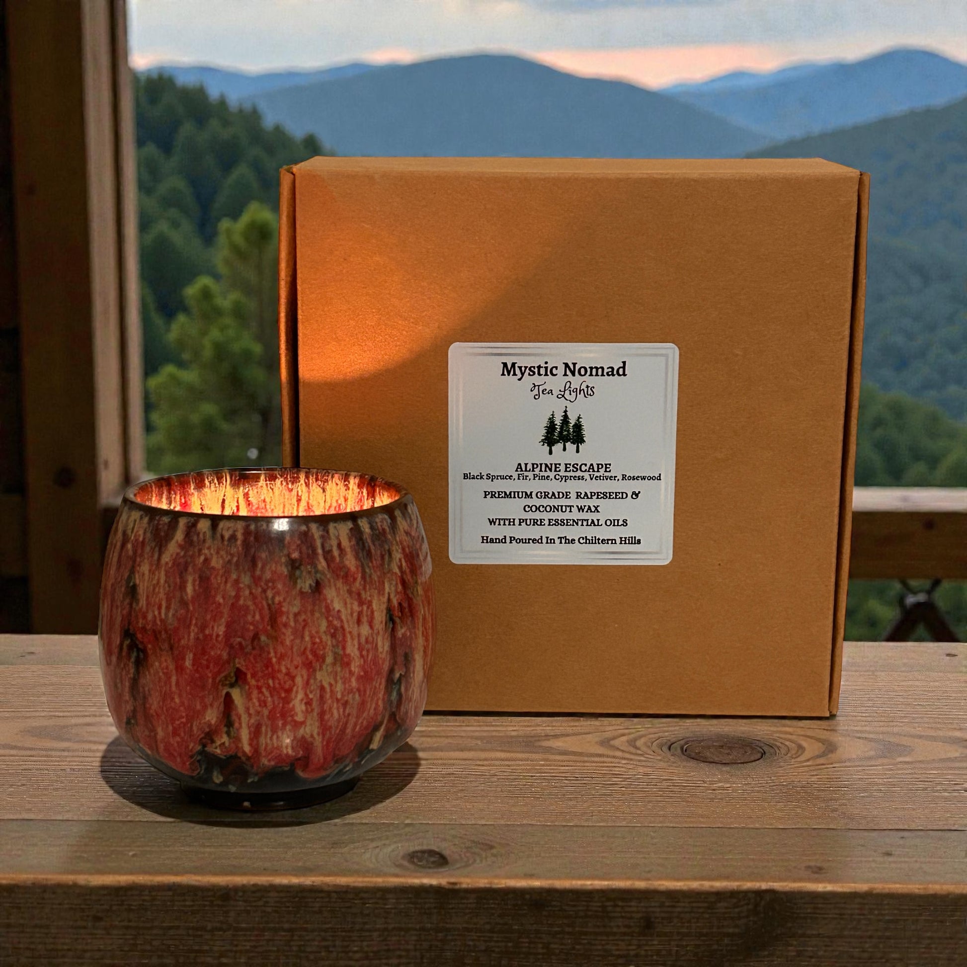 :Alpine Escape aromatherapy tea light with essential oils in holder with mountain backdrop, evoking grounding aromatherapy and forest-inspired calm
