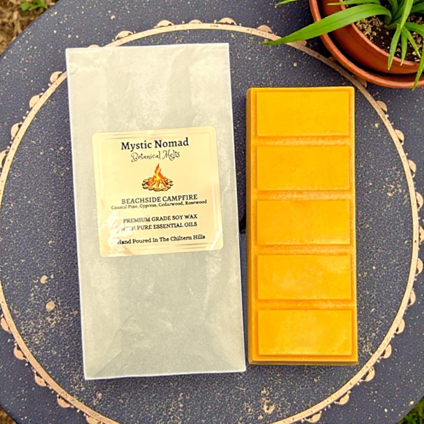 Beachside Campfire aromatherapy snap bar beside eco-friendly packaging, evoking warm coastal campfire fragrance