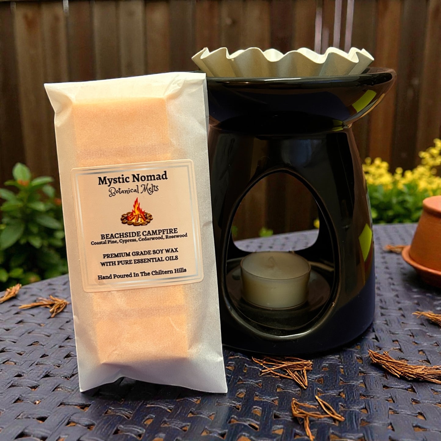 Beachside Campfire wax melt snap bar styled with a wax melt burner, creating a cosy beach-inspired home fragrance atmosphere