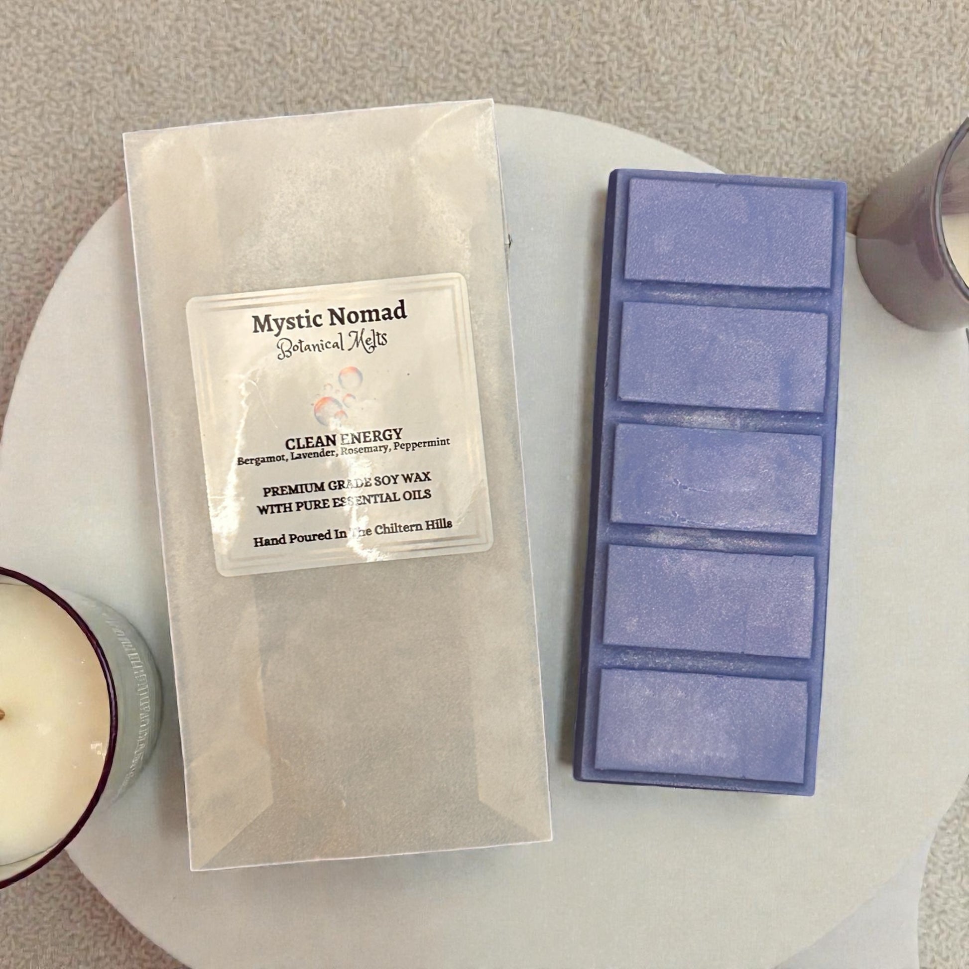 Clean Energy snap bar next to eco-friendly packaging, hand-poured with cleansing essential oils for mental clarity and relaxation