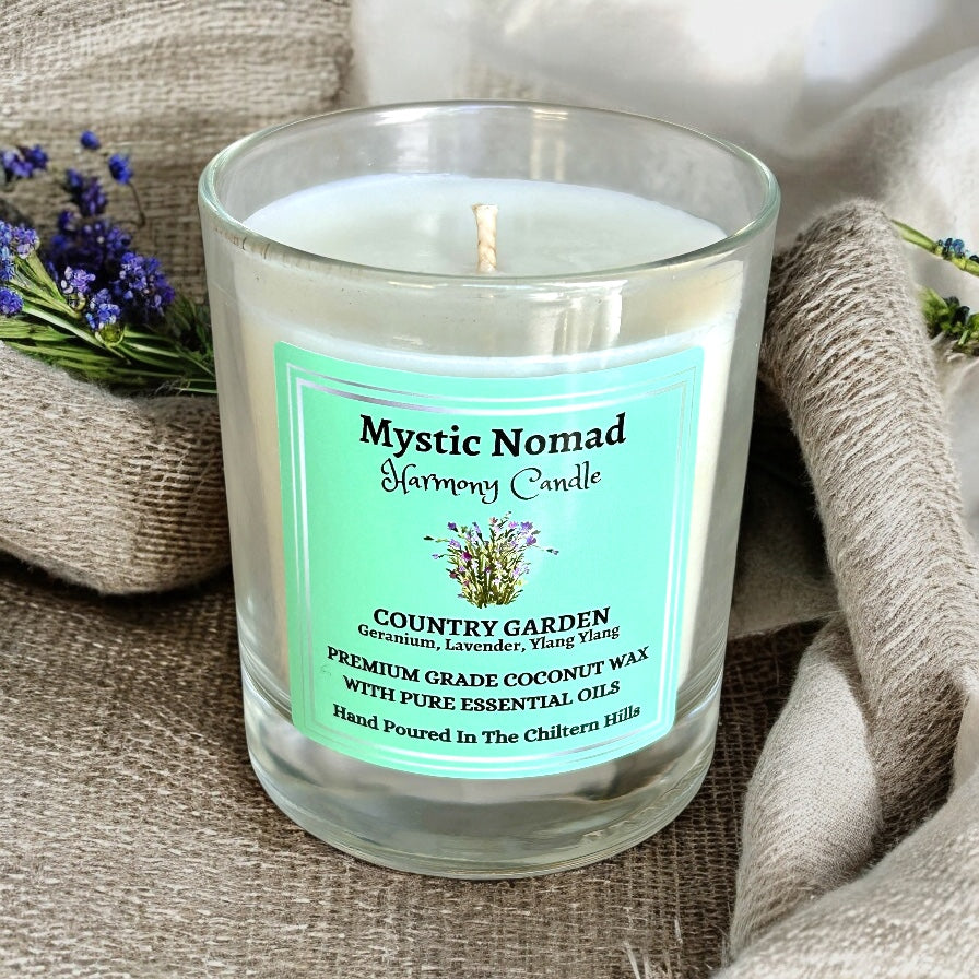 A close-up view of Mystic Nomad's Country Garden Candle with natural coconut and rapeseed wax, featuring a soothing blend of geranium, lavender, and ylang-ylang essential oils