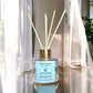 Elevated view of Country Garden reed diffuser with reeds, showing luxury Italian glass jar and floral aromatherapy blend