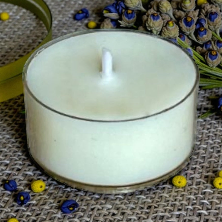 Close-up of a Dream Mist aromatherapy tea light, highlighting natural wax and cotton wick for a clean, soothing burn.