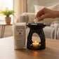 Alpine Escape wax melt snap bar next to ceramic burner in a calming lifestyle setting