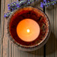 Country Garden aromatherapy tea light burning in ceramic holder, filling room with floral essential oils scent