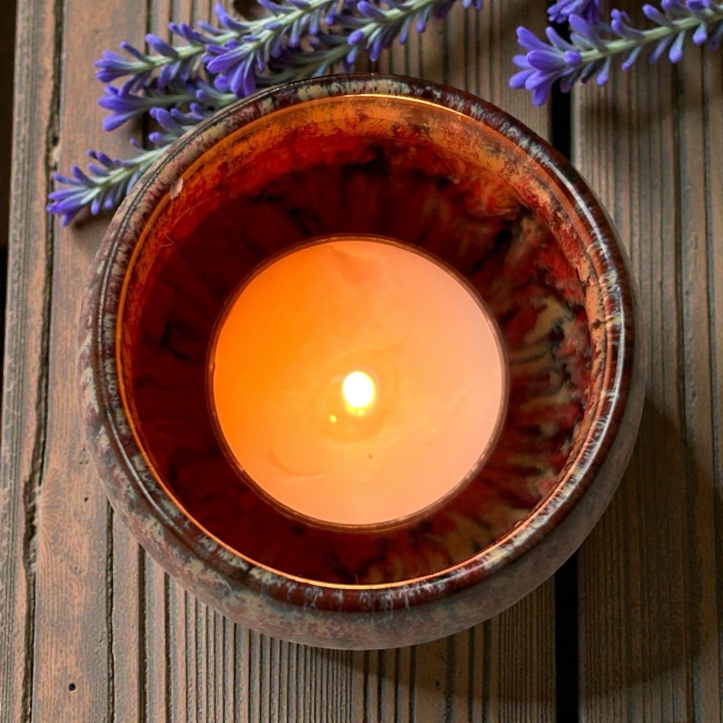 Country Garden aromatherapy tea light burning in ceramic holder, filling room with floral essential oils scent