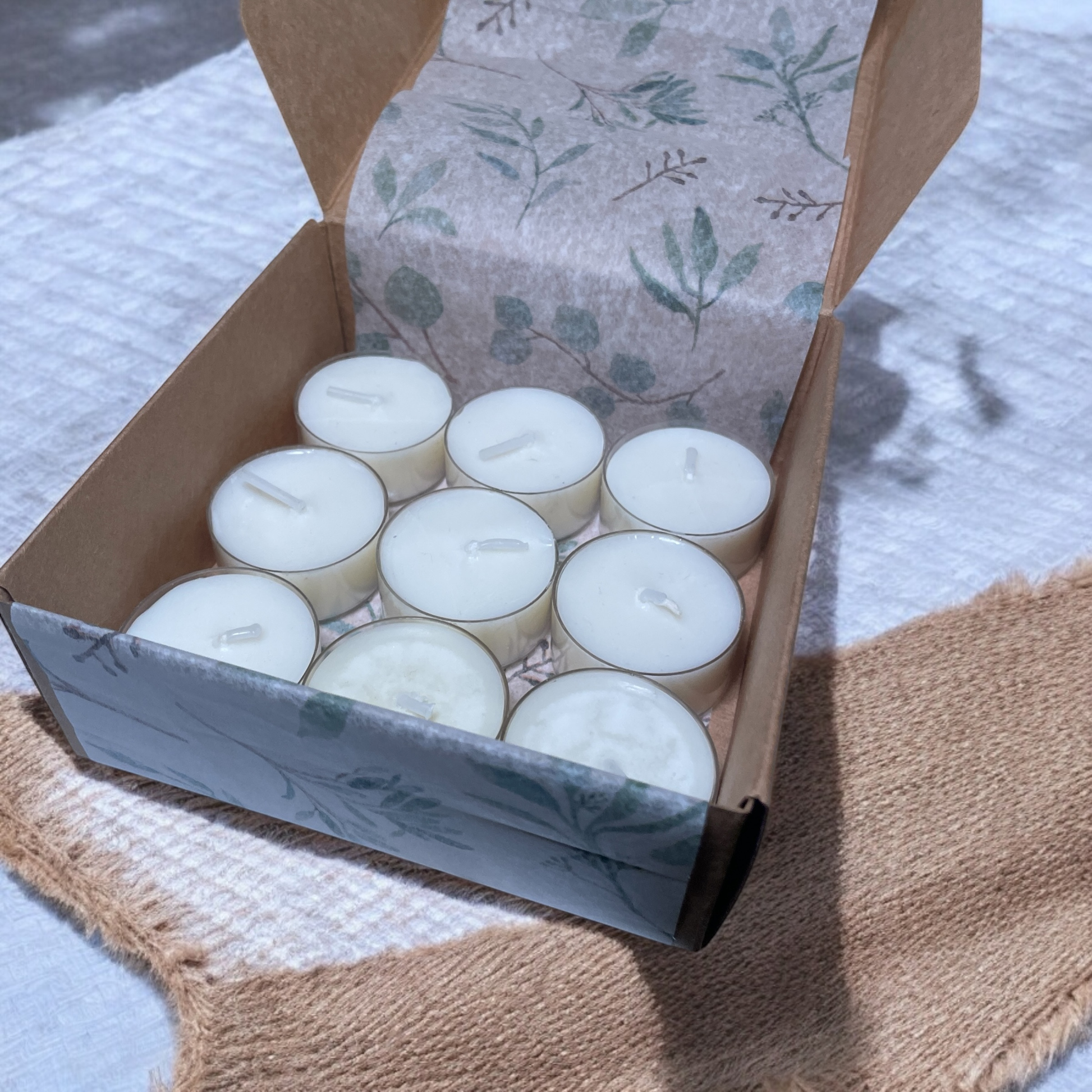 Open box of 9 Country Garden aromatherapy tea lights, hand-poured with Geranium, Lavender, and Ylang Ylang essential oils