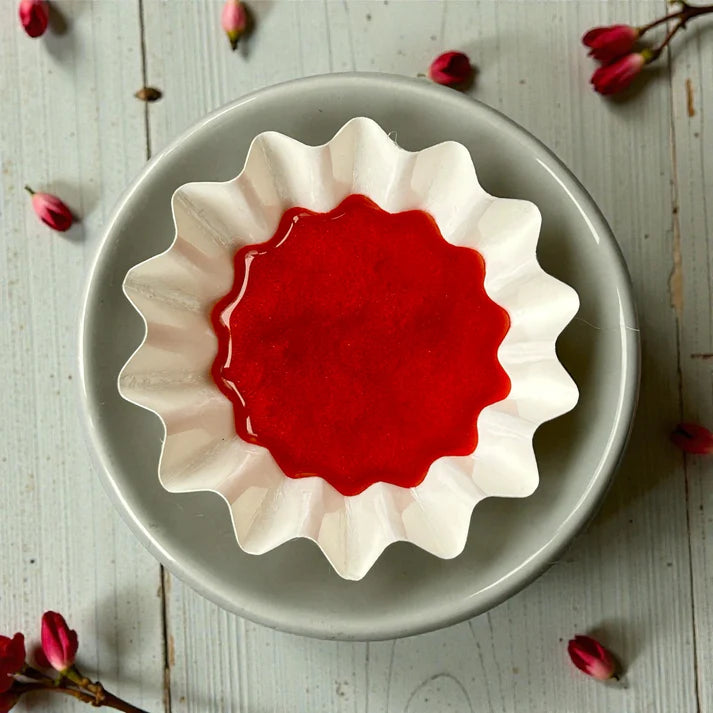 Reusable wax melt burner liner with red aromatherapy wax melt in essential oils