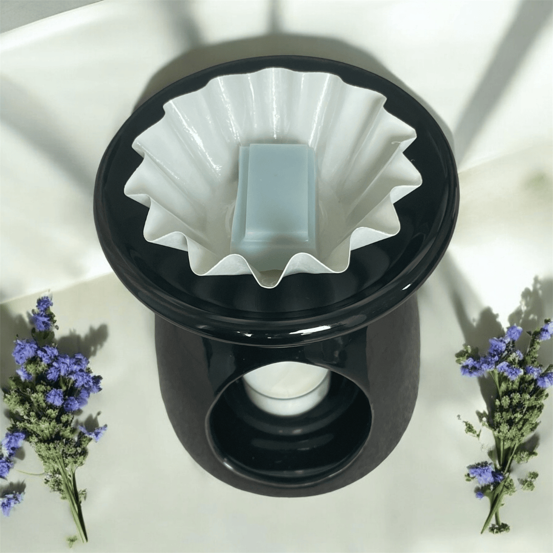 Wax melt burner liner shown with snap bar wax melt for aromatherapy candles