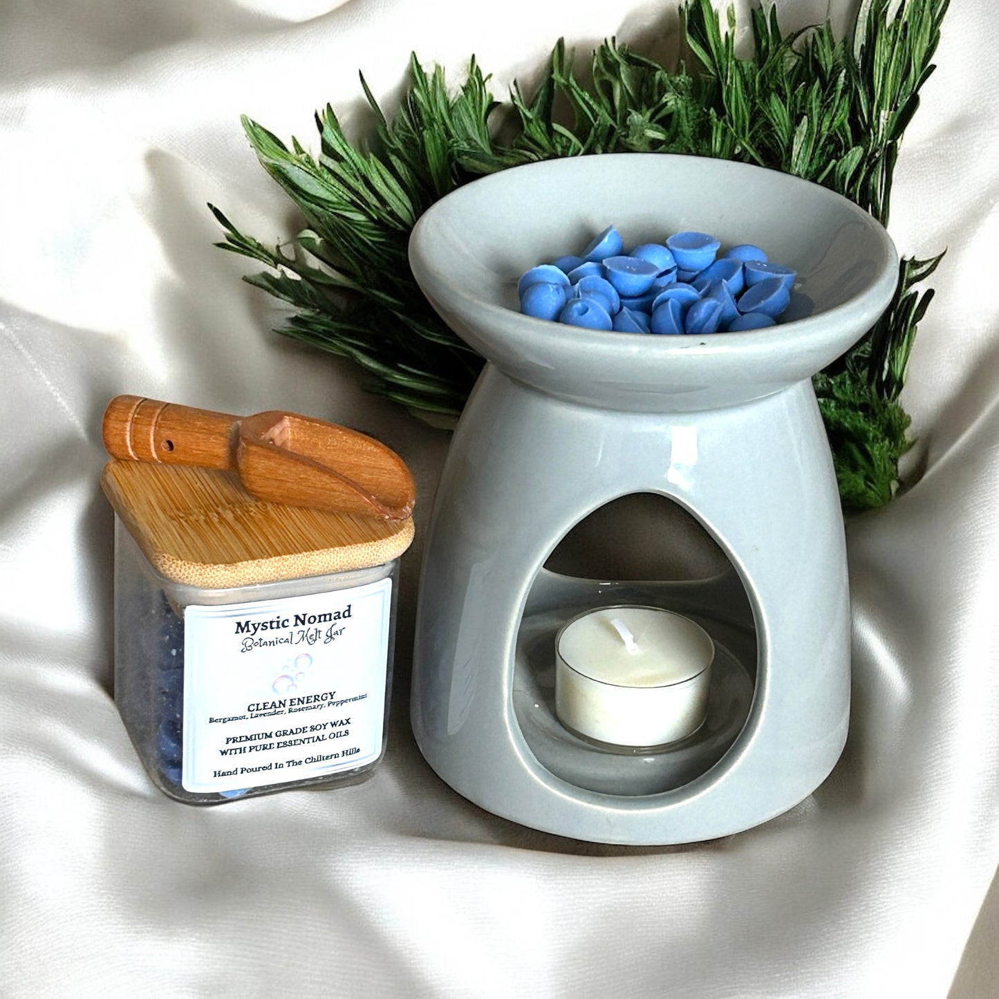 Mystic Nomad Clean Energy aromatherapy wax melts in wax burner, releasing uplifting scents of bergamot, lavender, rosemary, and peppermint to refresh home and mind.