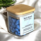 Side view of Mystic Nomad Clean Energy aromatherapy wax melts in glass jar with gold lid, highlighting hand-poured botanical blend of bergamot, lavender, rosemary, and peppermint.