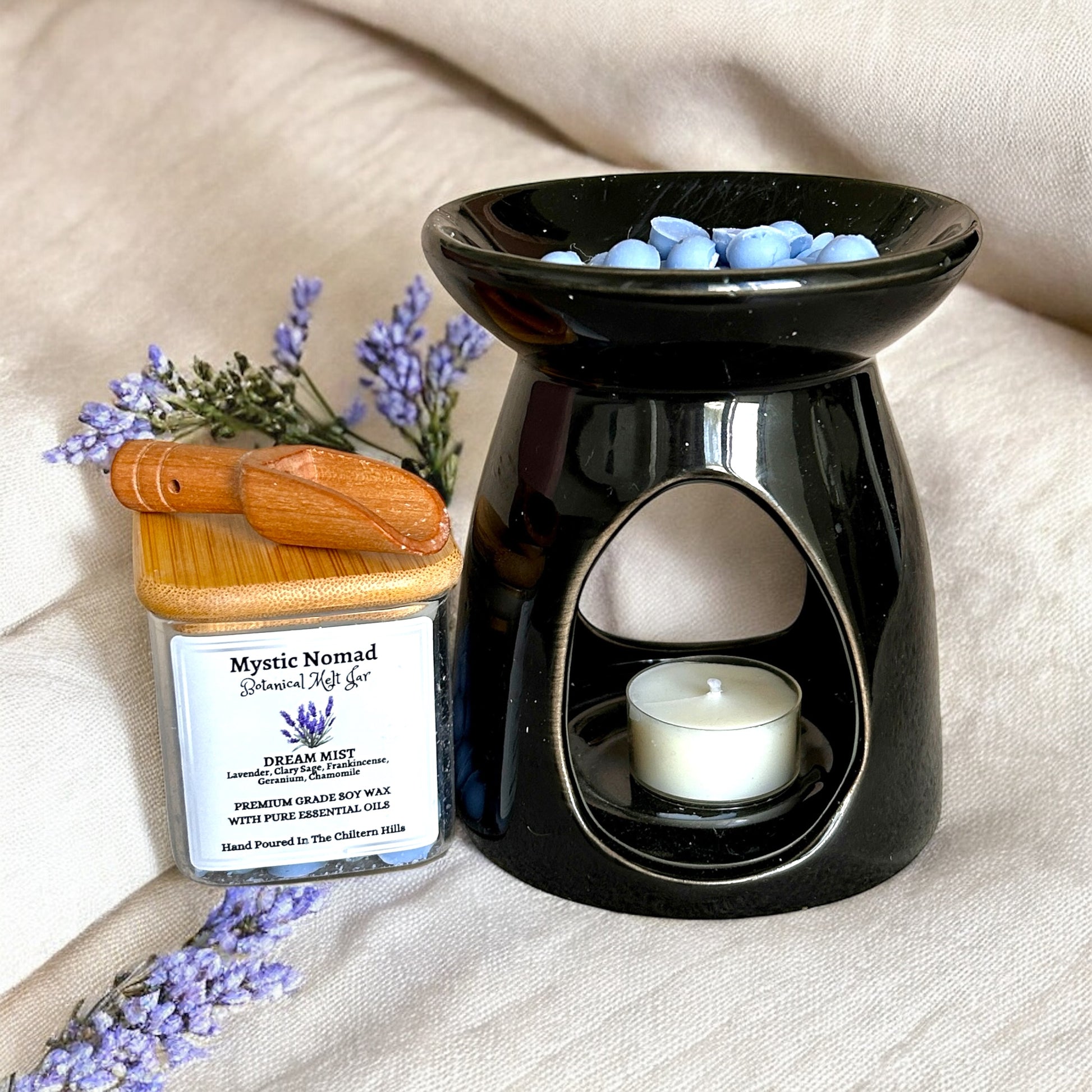 Dream Mist botanical wax melts displayed beside a wax melt burner for a calming sleep ritual