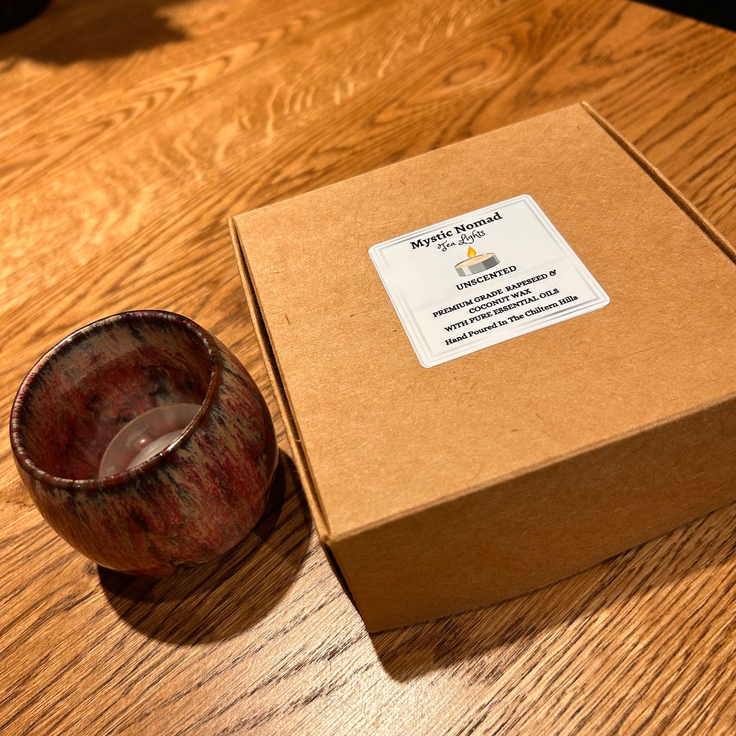 Additional flat lay of Mystic Nomad Aromatherapy eco-friendly unscented tea lights on a tabletop surface with ceramic holder.