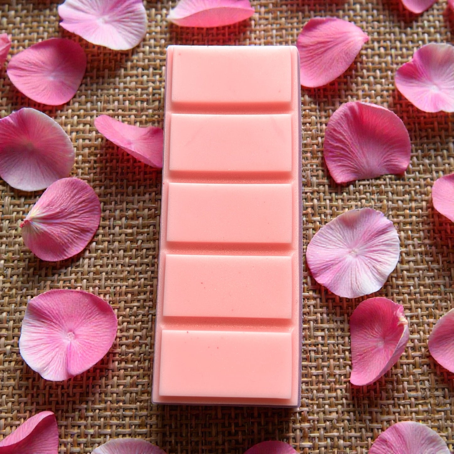 A flat lay of the Rose Bouquet aromatherapy wax melt by Mystic Nomad, featuring a floral rose geranium scent. Natural, hand-poured eco-friendly wax melt.