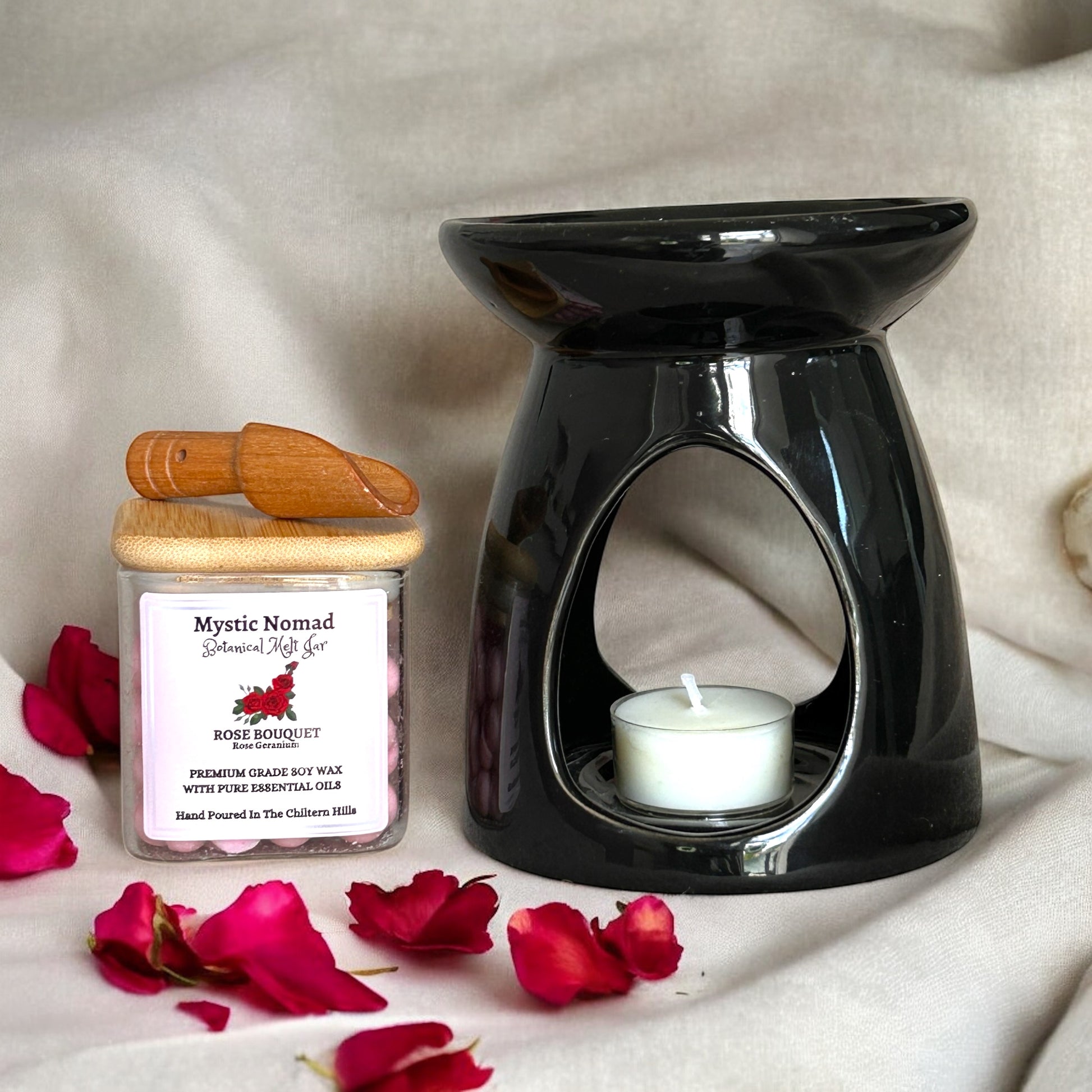 Mystic Nomad aromatherapy wax melts displayed beside a lit ceramic wax melt burner, showing a calming setup for anxiety relief.