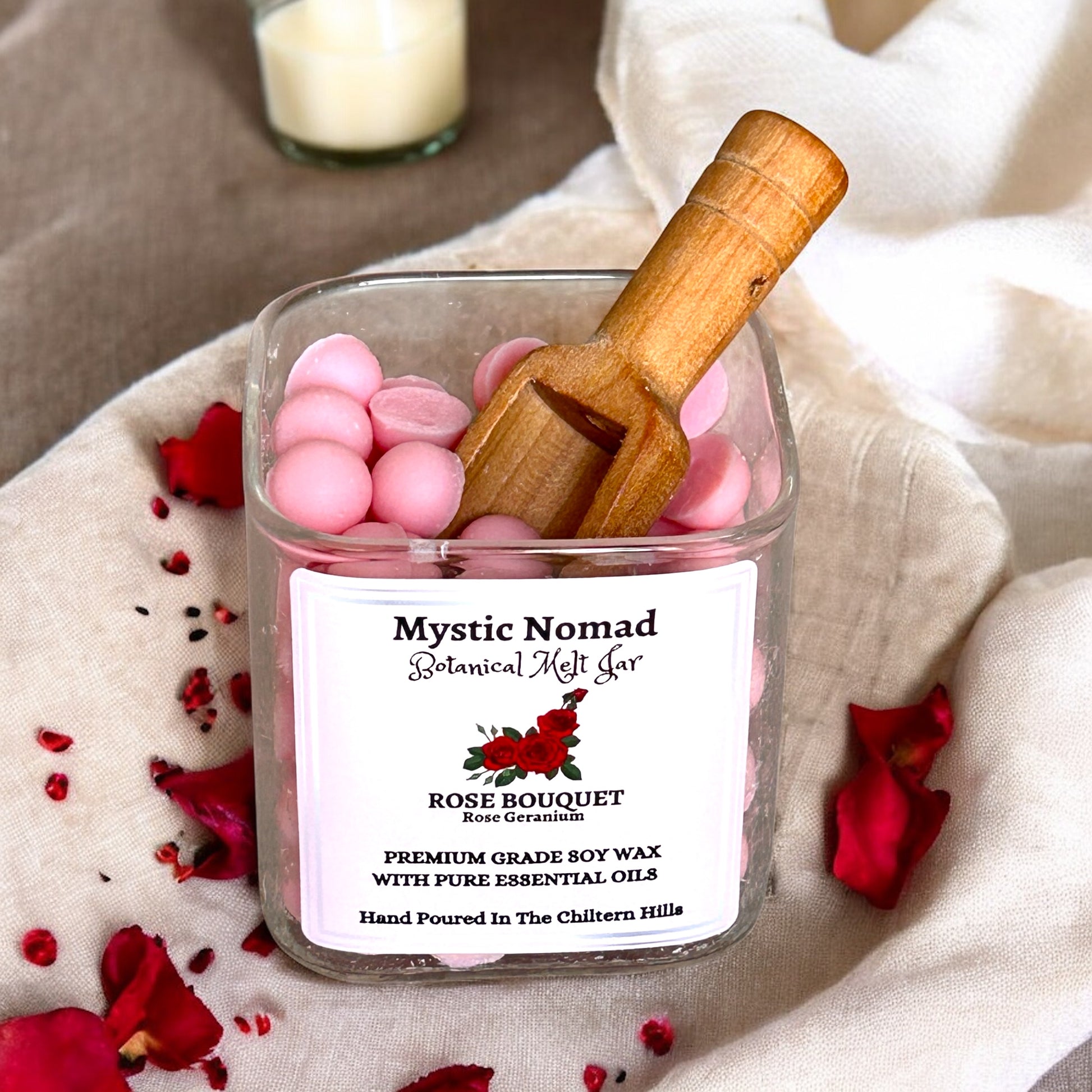 Top view of Mystic Nomad Rose Bouquet aromatherapy wax melts showing hand-poured rose-scented wax in a bamboo lid Italian glass jar.

