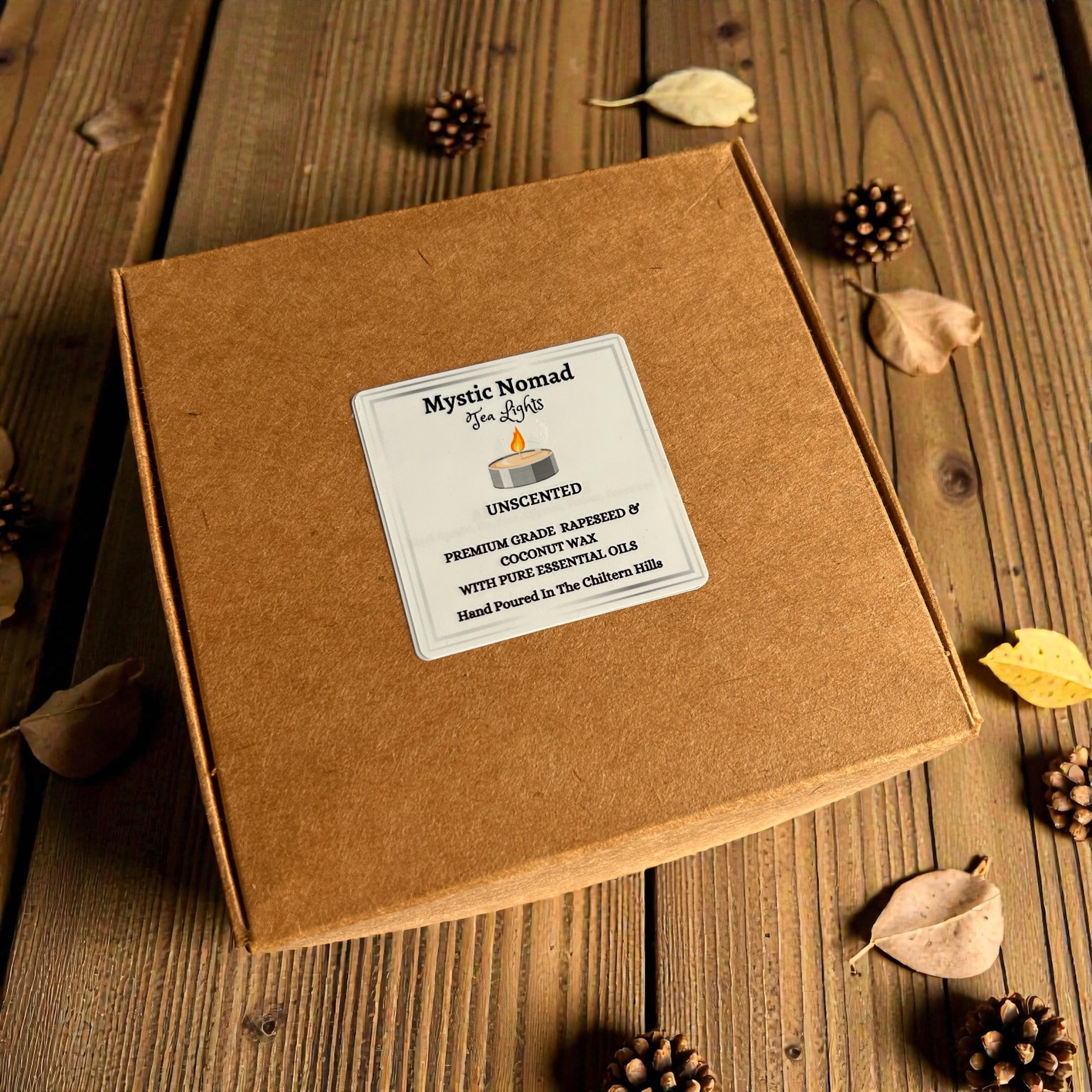 Flat lay of Mystic Nomad Aromatherapy unscented tea lights in an eco kraft box on a styled tabletop.