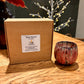 Box of eco-friendly Mystic Nomad Aromatherapy tea lights displayed with a ceramic tea light holder.