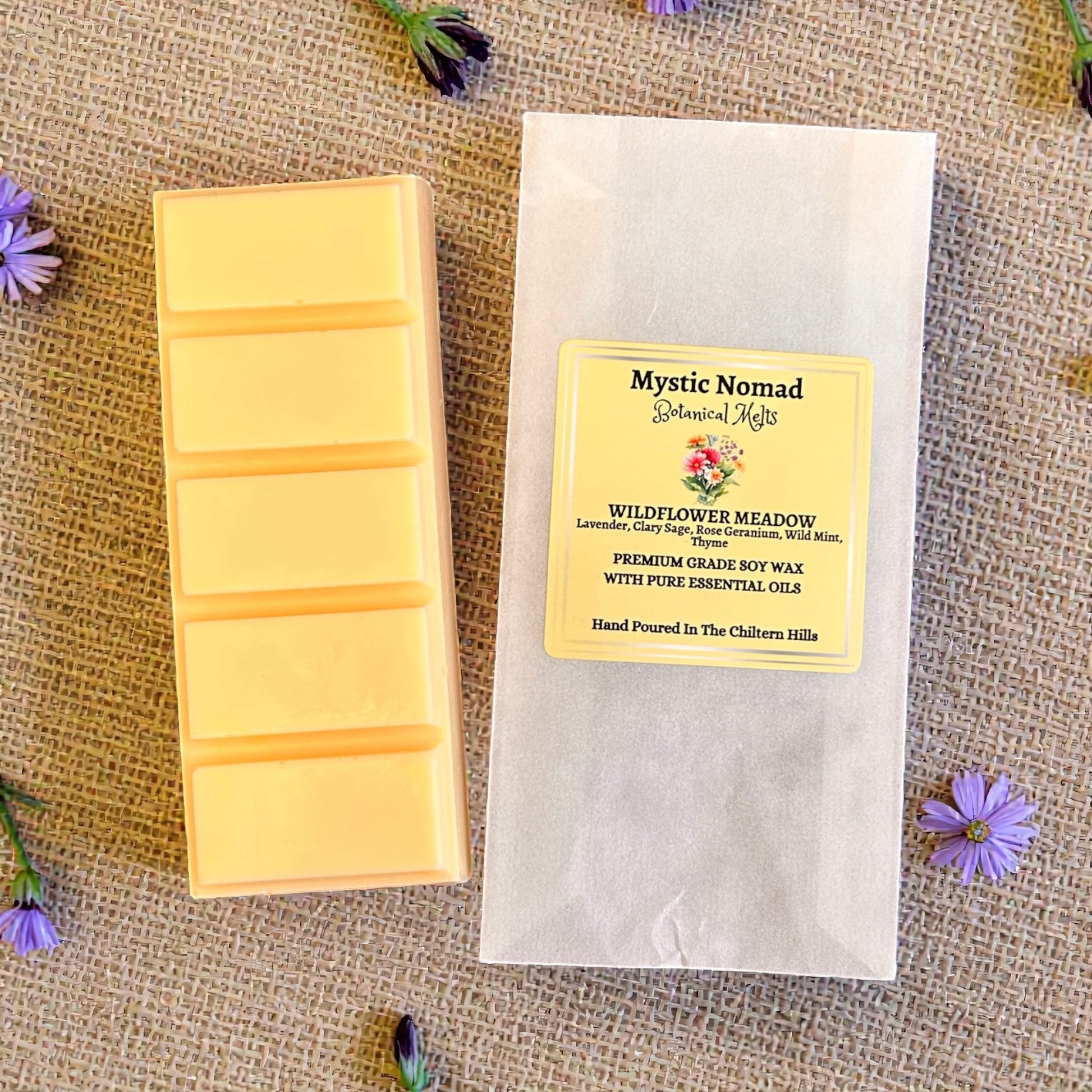 Wildflower Meadow wax melt snap bar displayed next to its eco-friendly packaging. Natural, hand-poured aromatherapy wax melt by Mystic Nomad.