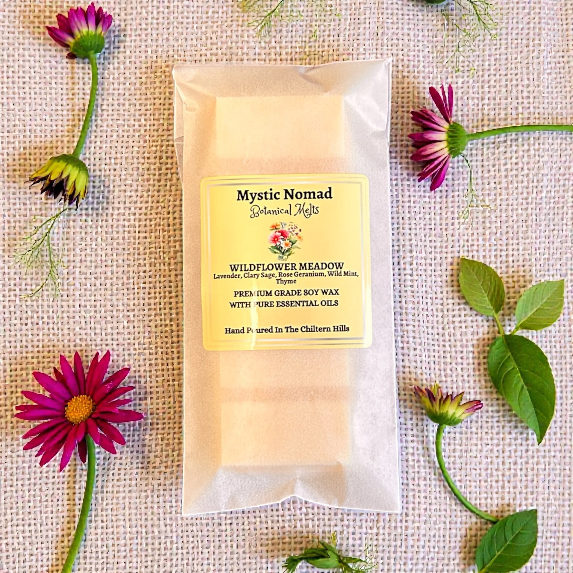 Wildflower Meadow aromatherapy wax melt snap bar in eco-friendly packaging, styled with flowers. Luxury hand-poured wax melt by Mystic Nomad.