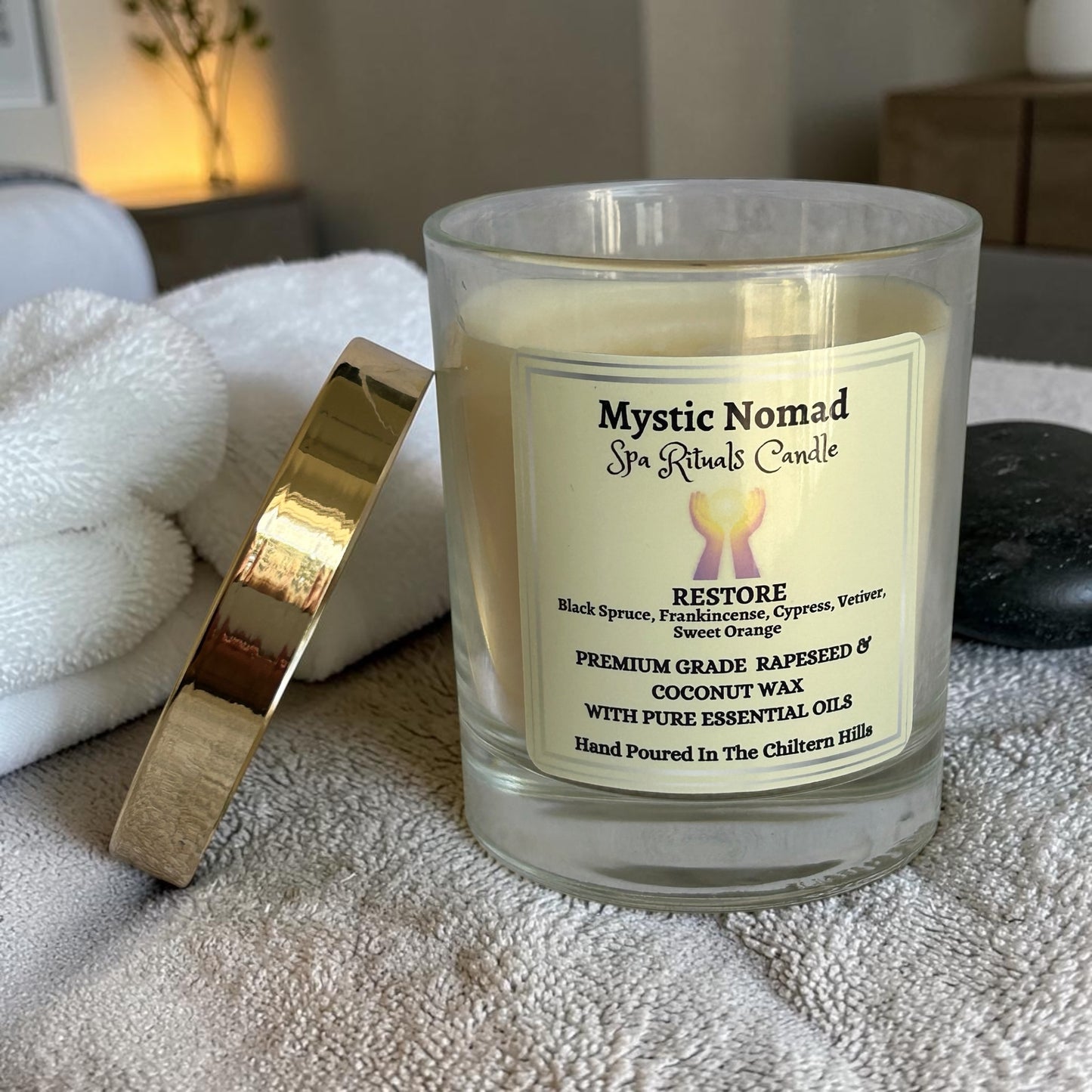 mystic nomad aromatherapy candle for restore to support energy on massage couch with lid