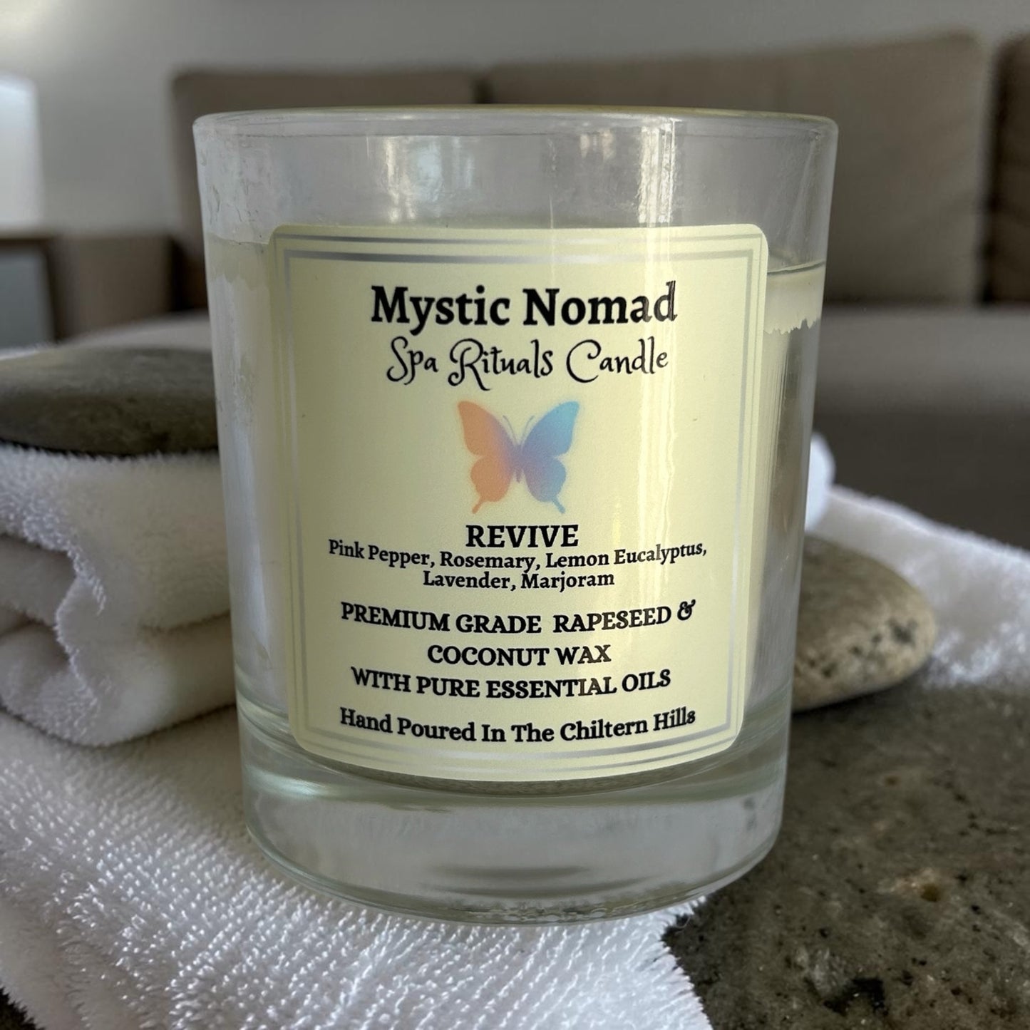 mystic nomad aromatherapy candle revive on spa background without lid
