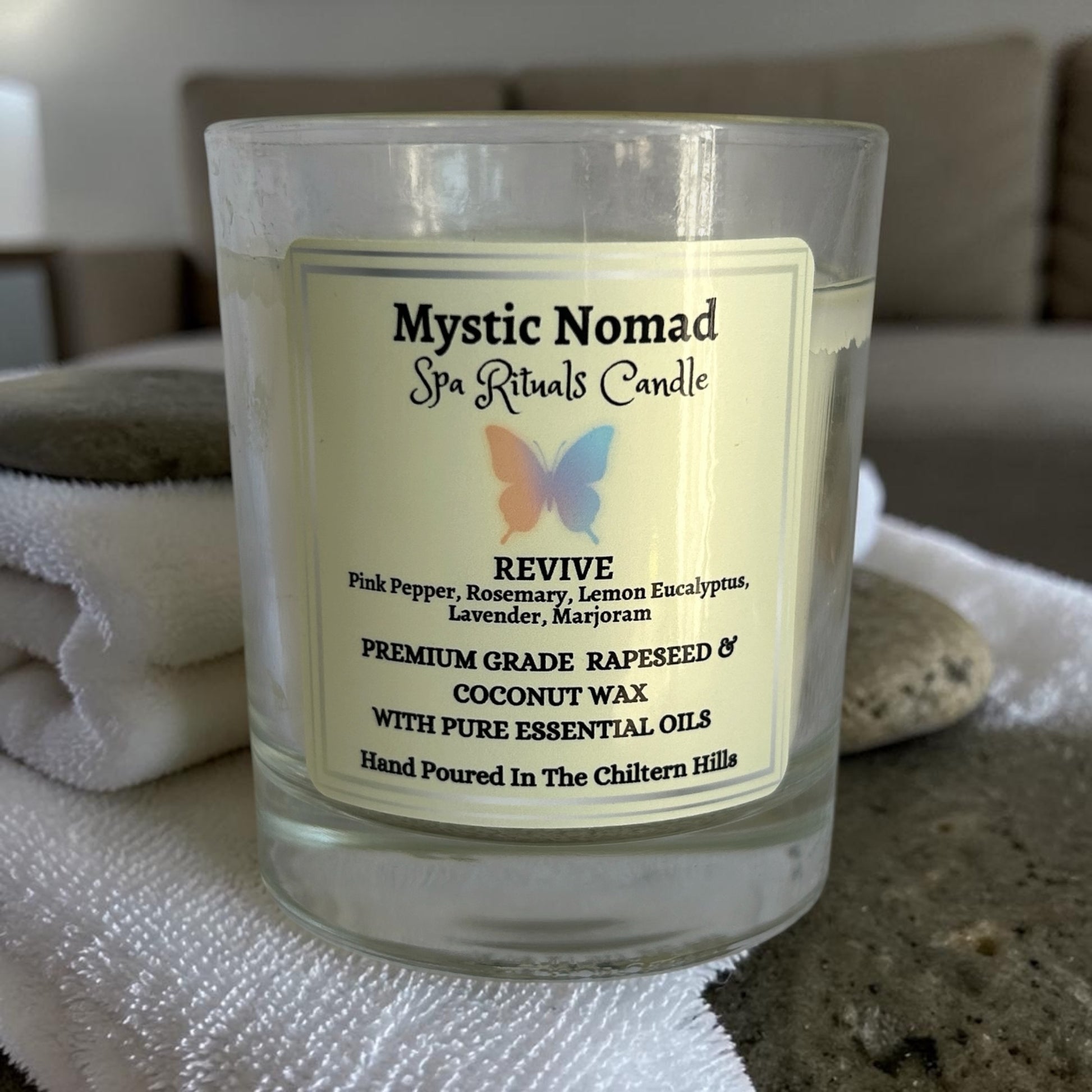 mystic nomad aromatherapy candle revive on spa background without lid
