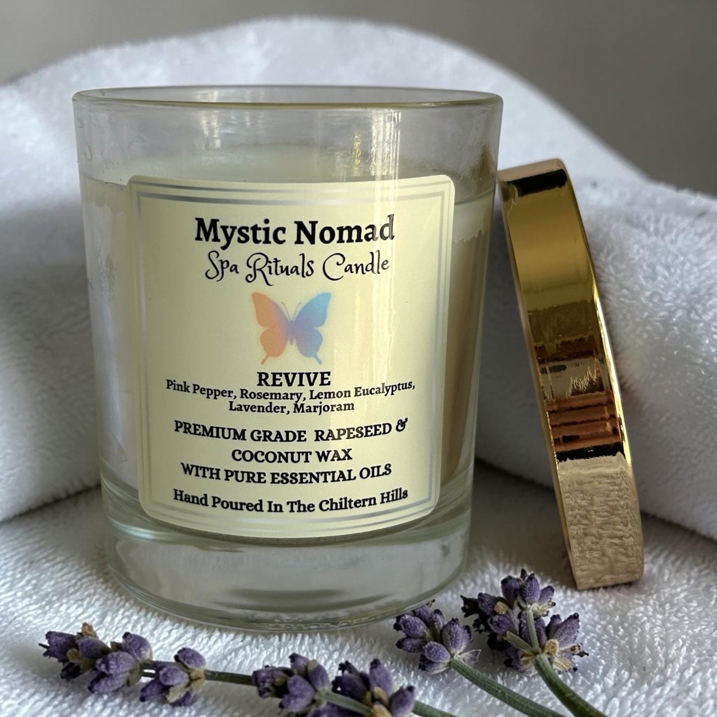 mystic nomad aromatherapy candle revive with lavender sprigs