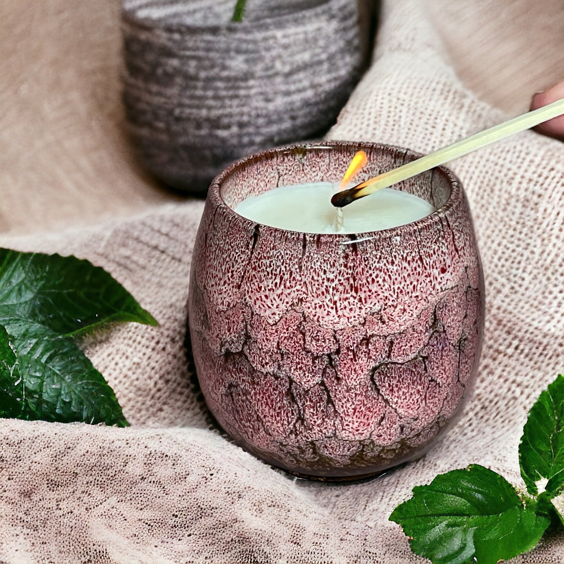 Relax & Renew lavender aromatherapy candle being lit with a match, symbolising a calming bedtime relaxation ritual.