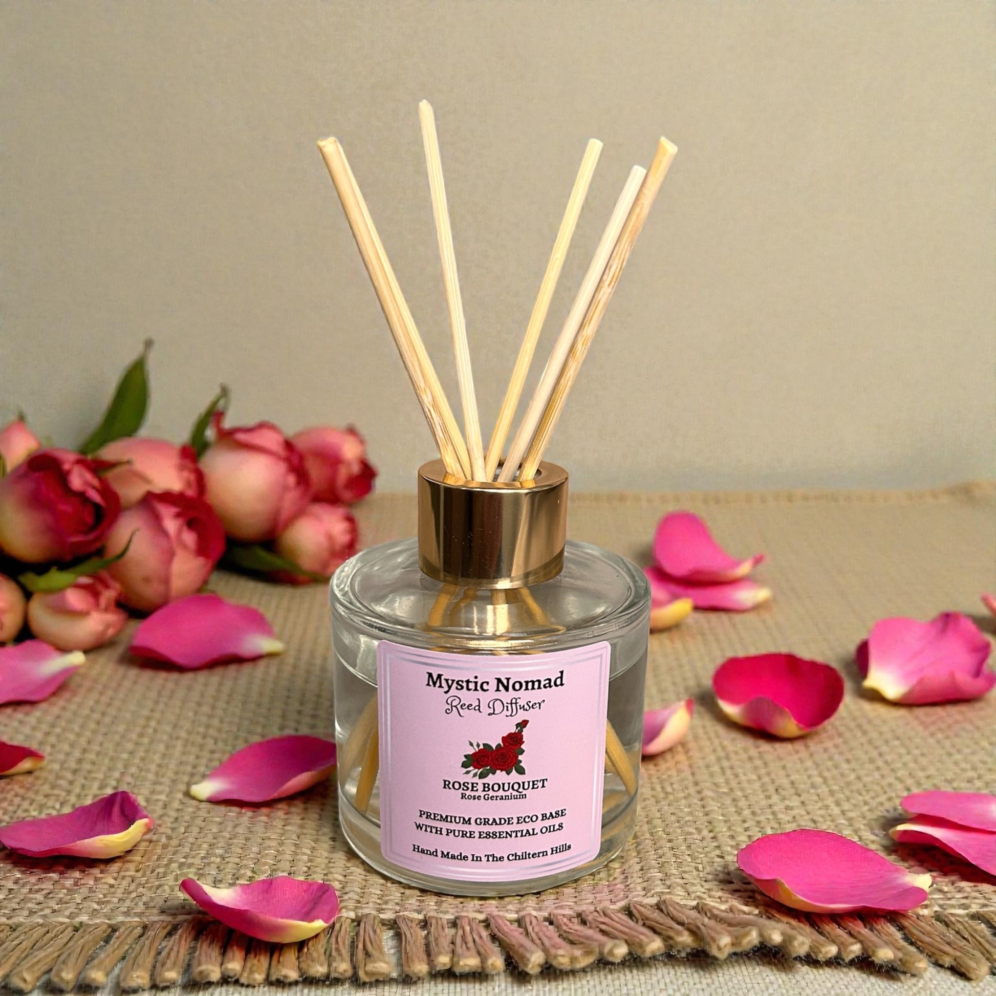 Rose Bouquet diffuser bottle with reeds arranged neatly beside it, showcasing eco-friendly design and luxury aromatherapy craftsmanship.
