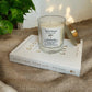 Summer Breeze candle on a book, styled to show relaxing and mindful home ambiance with eco-friendly aromatherapy candle.
