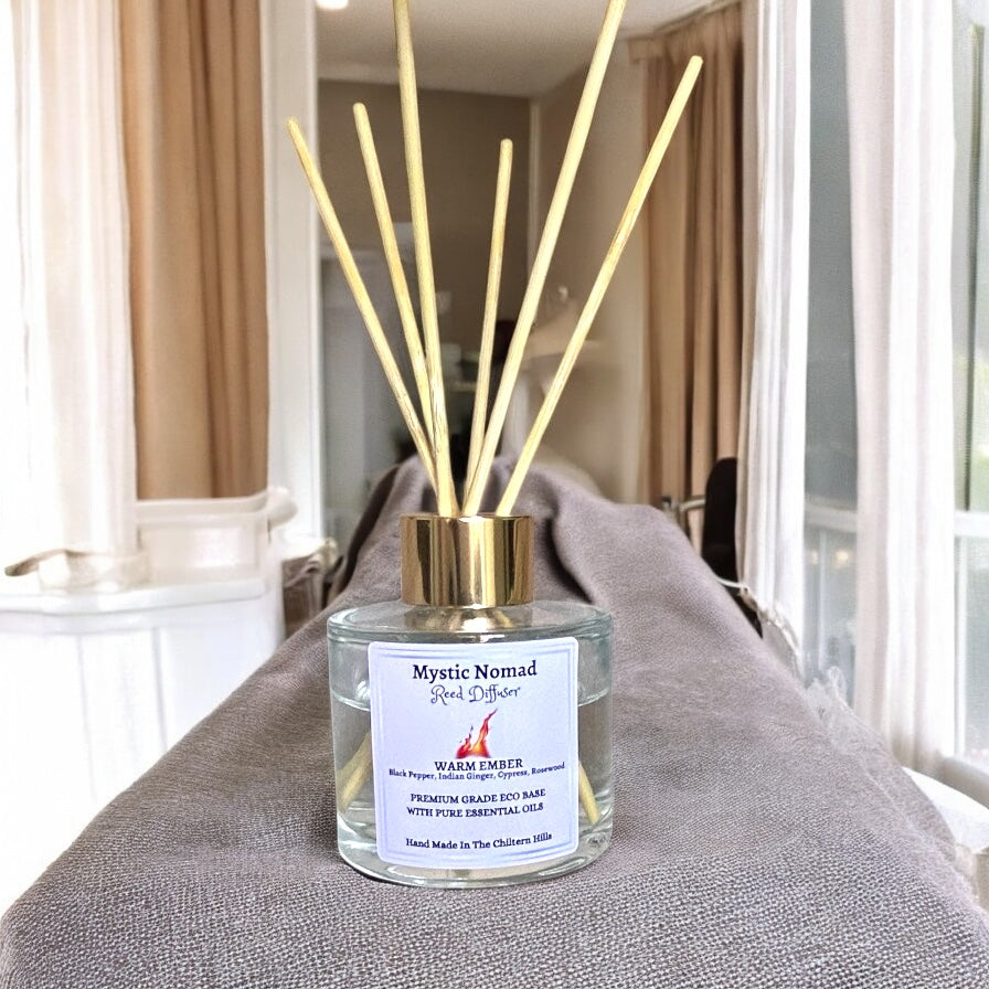Warm Ember reed diffuser with natural reeds inserted, hand-poured by Mystic Nomad Aromatherapy to fill your home with a spicy, grounding aroma for mindfulness and emotional balance