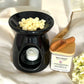 Wildflower Meadow wax melts placed in a burner, gently melting and releasing floral-herbal aroma