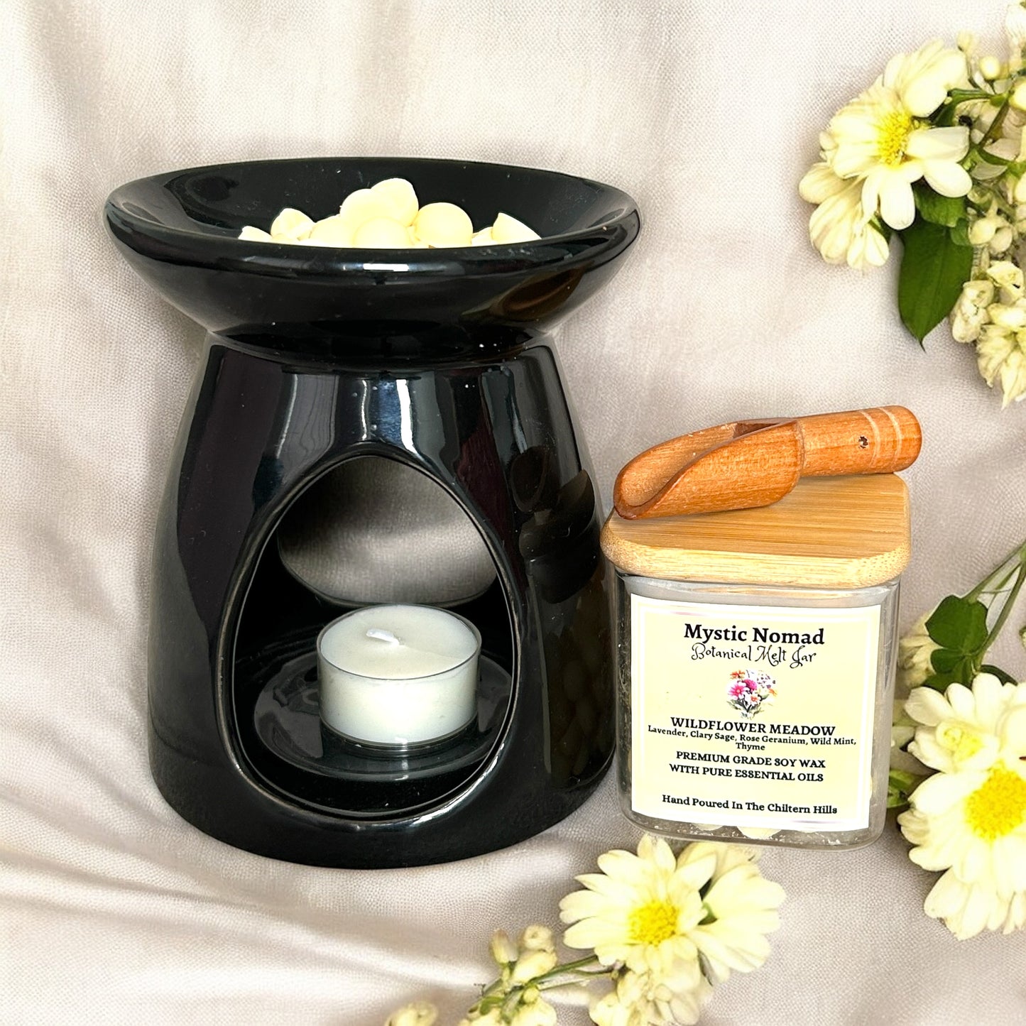 Melted Wildflower Meadow wax in a burner, filling the room with calming floral-herbal aromatherapy