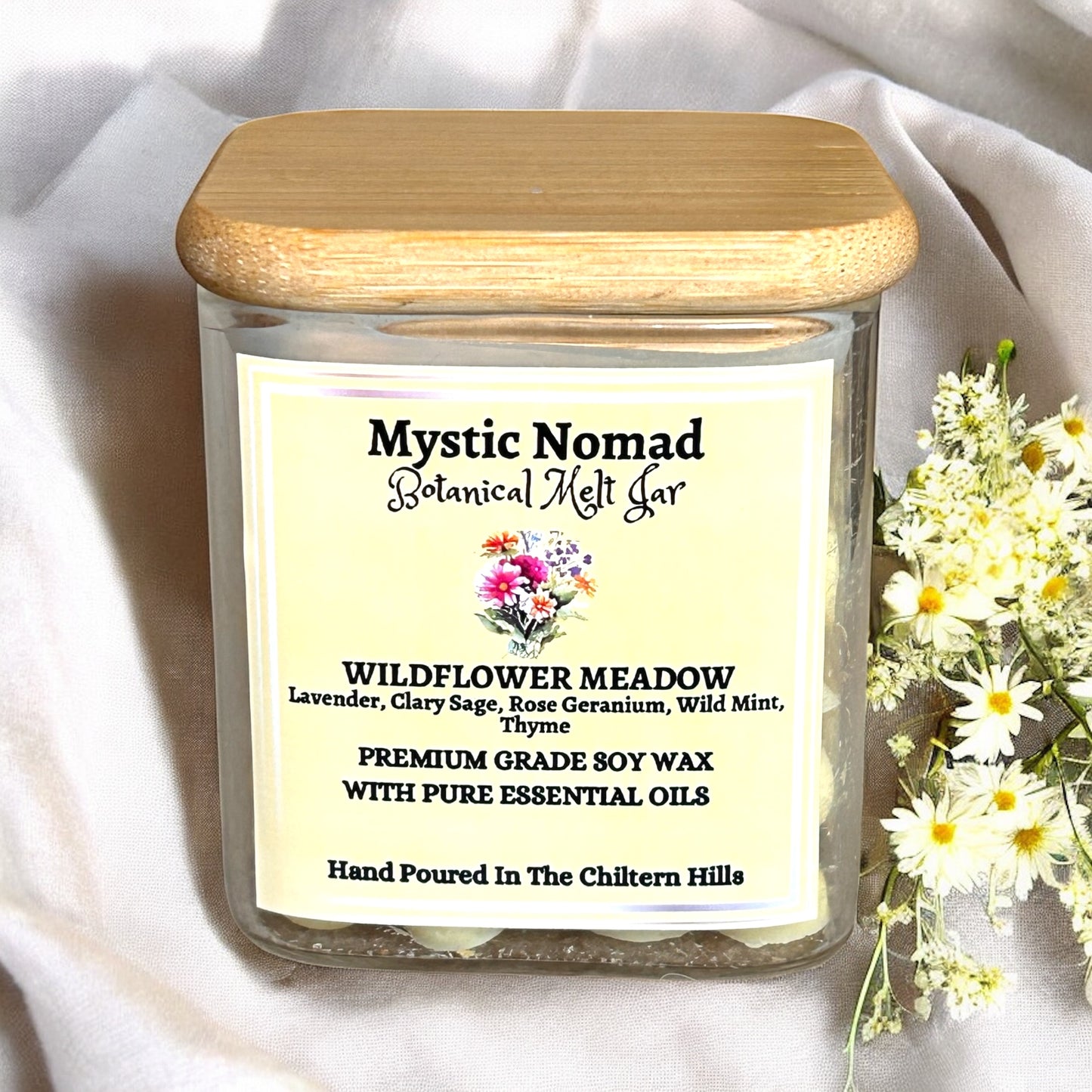 Wildflower Meadow botanical wax melts in eco-luxury glass jar with gold lid, filled with floral-herbal scented wax